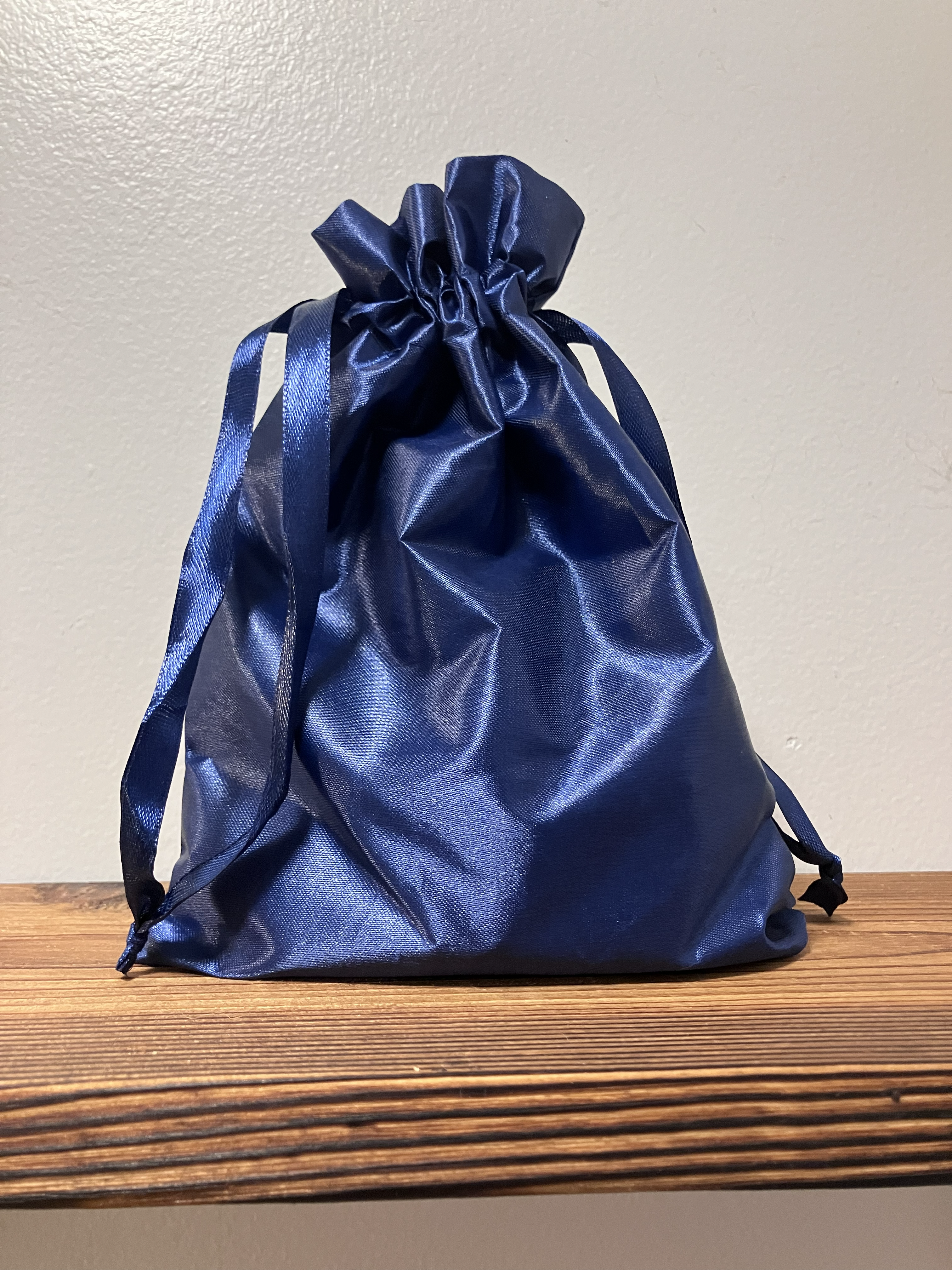 Fraggle's ashes in their original satin cremation bag
